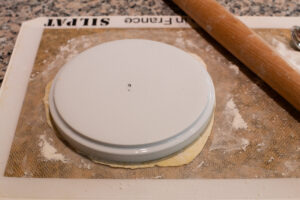 Cutting a circle of dough.